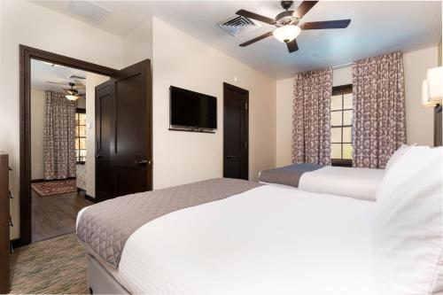 a bedroom with two beds and a flat screen tv at The Ranch At Death Valley in Death Valley