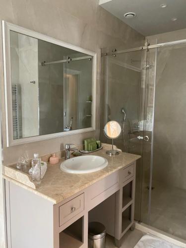 a bathroom with a sink and a shower at Villa Promenade in Burgas City