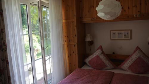 a bedroom with a bed and a large window at Ferienwohnung Hummel in Bad Buchau