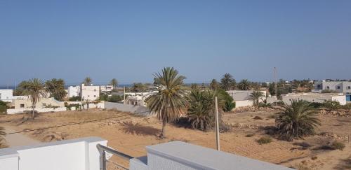 a view of a city with palm trees and buildings at Villa Aline Lagune Djerba in Midoun