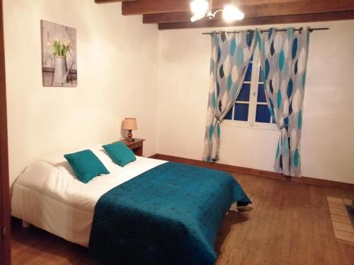 a bedroom with a bed and a window at Villa Lélou in Les Mignots