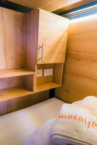 a small bedroom with a bed and wooden walls at Masaya Bogotá in Bogotá