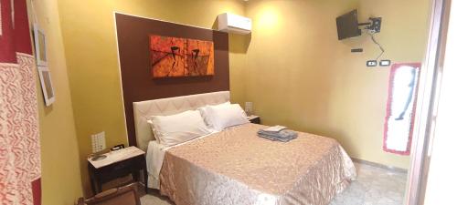 a bedroom with a bed and a painting on the wall at B&B miccoli in Grottaglie