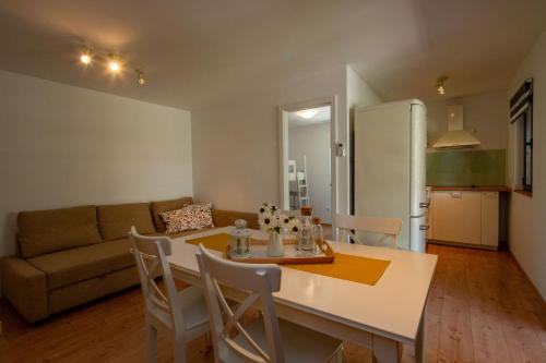 a kitchen and living room with a table and chairs at Kamp Mara in Pakoštane