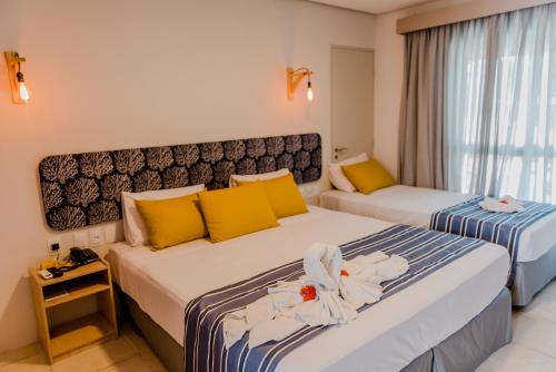 En eller flere senge i et værelse på Baía Branca Beach Resort