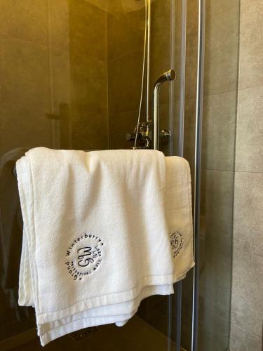 a towel is hanging on a shower stall at Grand Winterberry - Lake View Luxury Residence in Nuwara Eliya