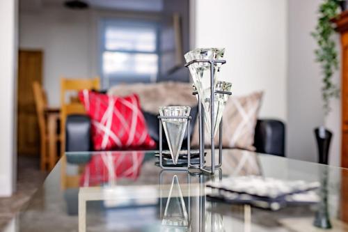 a glass table in a living room with a couch at Hibbert Galore in Barrow in Furness