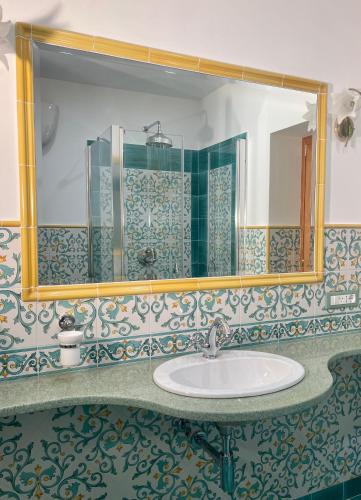 a bathroom with a sink and a mirror at Casa Aprea in Sorrento