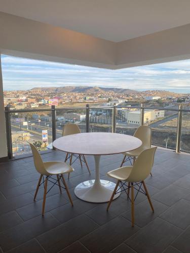 a table and chairs on a balcony with a view at Fiesta Inn Zacatecas in Zacatecas