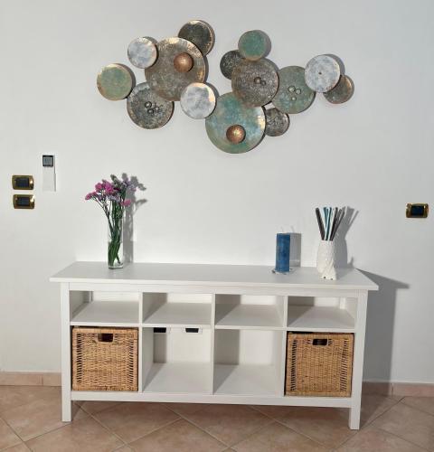 a white table with plates on the wall at Casa Aprea in Sorrento