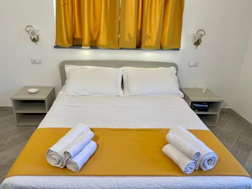 a bedroom with a bed with towels on it at Casa Aprea in Sorrento
