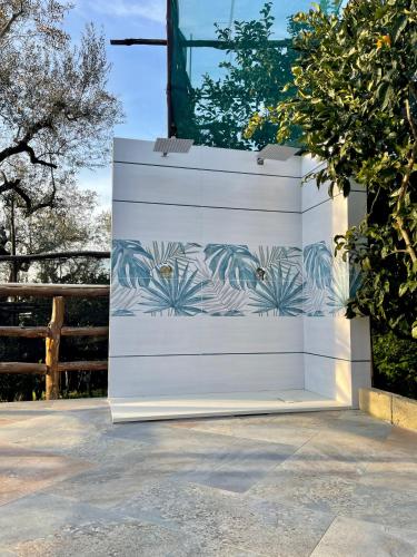 a white garage door with a mural of plants at Casa Aprea in Sorrento