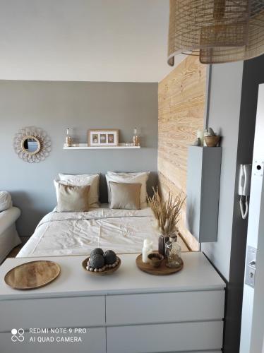 a bedroom with a bed with a tray of food on it at appartement belle vue in Courseulles-sur-Mer