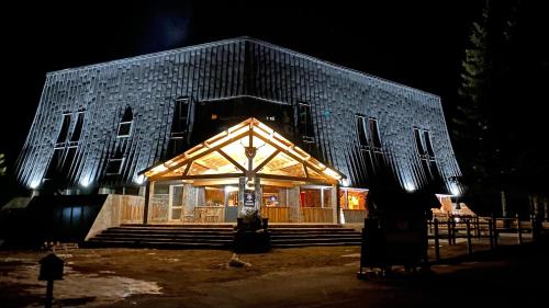 a building with a lit up facade at night at MONTLO RELAIS DES CERFS in Cubières