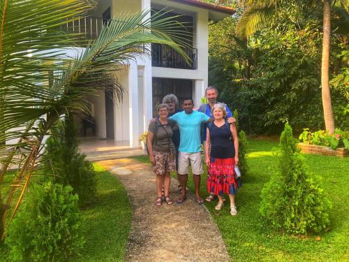 a group of people standing in front of a house at Manike Lodge Habarana in Habarana