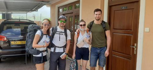 a group of people standing outside of a building at Mount View Bungalow in Hatton