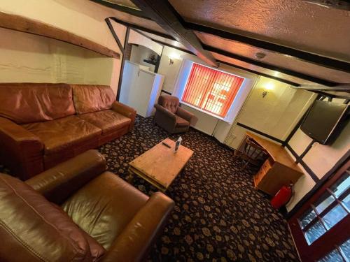 an overhead view of a living room with a couch and a tv at The Horse and Groom in Swaffham