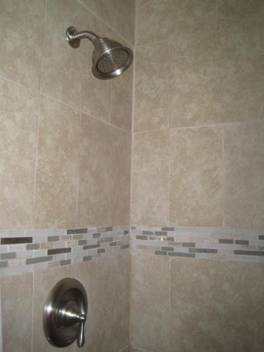 a shower with a shower head in a bathroom at Miami Sun Hotel - Downtown/Port of Miami in Miami