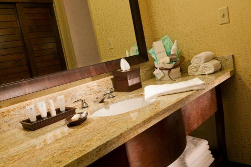 a bathroom sink with toothbrushes on it at Glenwood Hot Springs Resort in Glenwood Springs