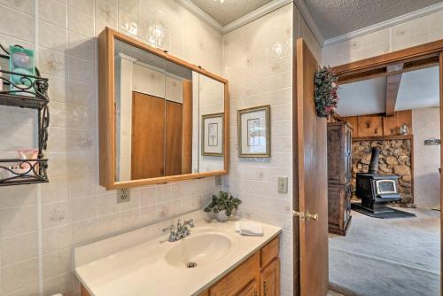 a bathroom with a sink and a mirror and a stove at The Lakehouse Lovely Wappapello Country Home! in Wappapello