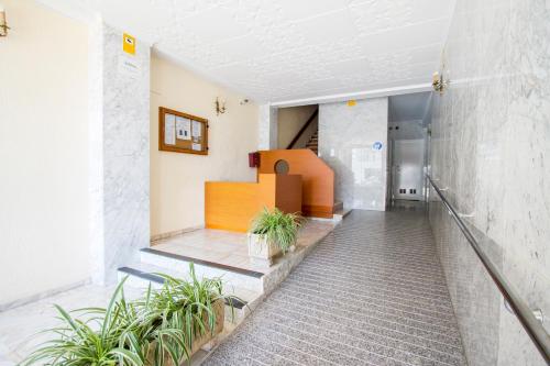 a staircase in a building with potted plants at PRIMERISIMA LINEA DE PLAYA - CULLERA BAHIA DE LOS NARANJOS I in Cullera