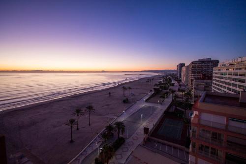 a view of a beach and the ocean at sunset at PRIMERISIMA LINEA DE PLAYA - CULLERA BAHIA DE LOS NARANJOS I in Cullera