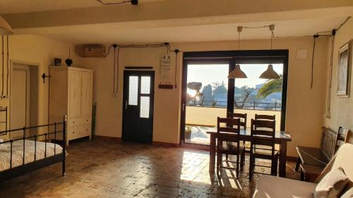a room with a table and a kitchen with a window at Studio-apartments Monfort in Portorož