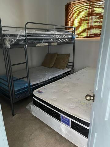 two bunk beds in a room with a window at Wasaga Beach Cottage 2 in Wasaga Beach