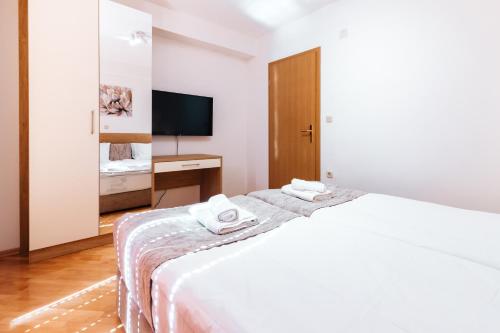 En eller flere senge i et værelse på TI Central Apartment