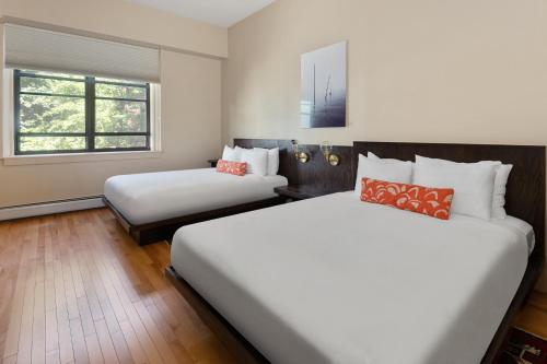 a hotel room with two beds and a window at The Francis Hotel in Portland