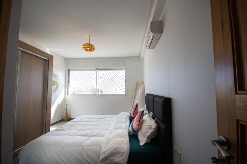 a bedroom with two beds and a window at NjoY Morocco in Tamraght Ouzdar