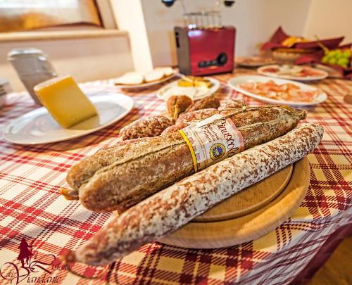 a table topped with bags of bread and cheese at Il Ristoro Del Viandante in Offagna