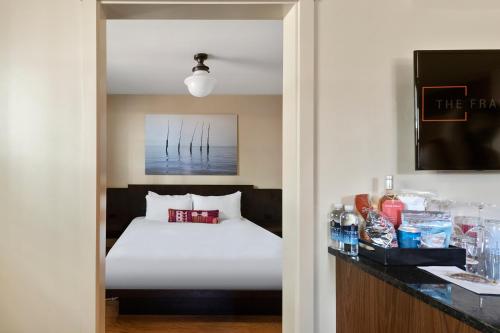 a hotel room with a bed and a table with drinks at The Francis Hotel in Portland