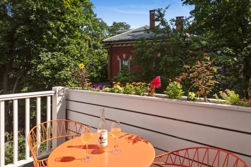 a table with two glasses of wine on a balcony at The Francis Hotel in Portland