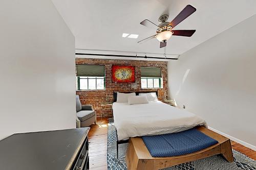 a bedroom with a bed and a ceiling fan at The Basecamp in Savannah