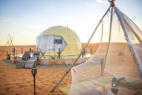 a tent in the middle of the desert at Starry Domes Desert Camp in Bidiyah