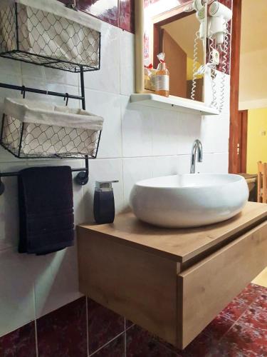 a bathroom with a large white sink on a wooden counter at Villa Mateja in Novalja