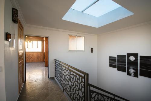 a skylight in a room with a hallway with a staircase at NjoY Morocco in Tamraght Ouzdar