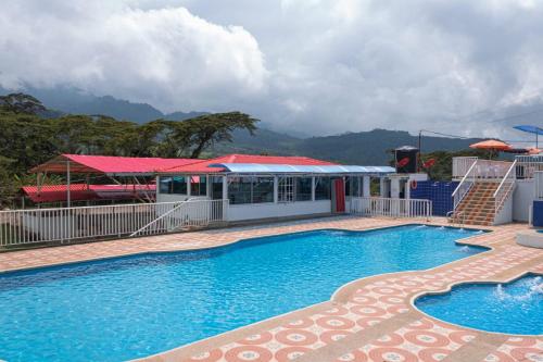 a large swimming pool in front of a building at Club Recreativo Las Guitarras in Florián