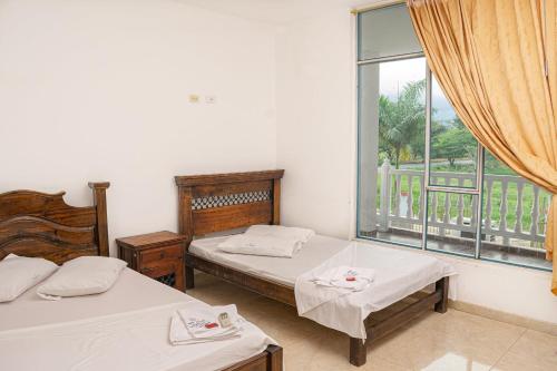 Een bed of bedden in een kamer bij HOTEL CAMPESTRE VILLAS de SANTA RITA