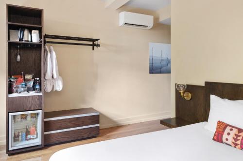 a bedroom with a bed and a book shelf at The Francis Hotel in Portland
