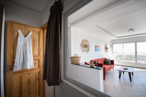 a white dress hanging on a door in a living room at NjoY Morocco in Tamraght Ouzdar