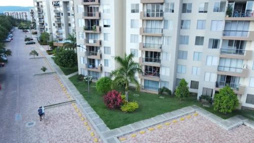 a person standing in front of a large apartment building at Apartamento en Ricaurte in Ricaurte