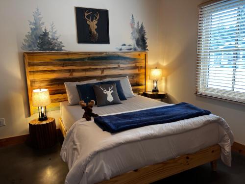 a bedroom with a bed with a teddy bear on it at Enchantment Lodges - 5 min walk to downtown in Leavenworth