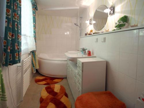 a bathroom with a sink and a toilet and a mirror at Bungalow garden idyll, Berlin in Berlin