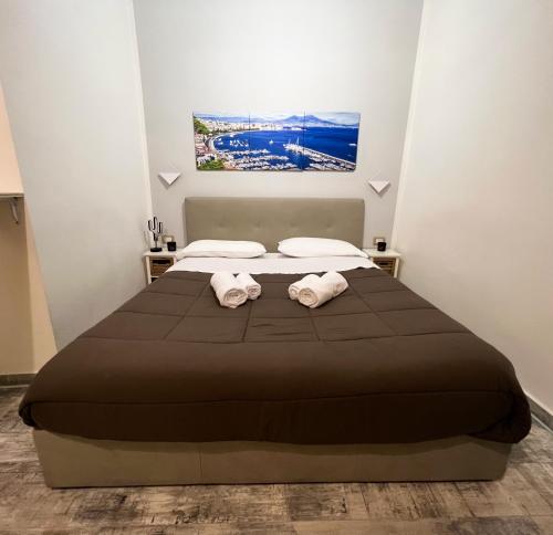 a bedroom with a bed with two towels at CASA MARTINO FORMALE in Naples