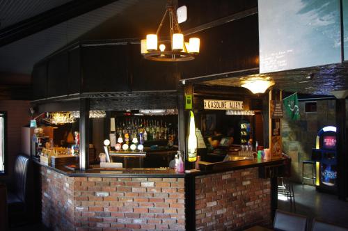 a bar in a restaurant with a brick wall at South Hill Lodge in Prince Albert