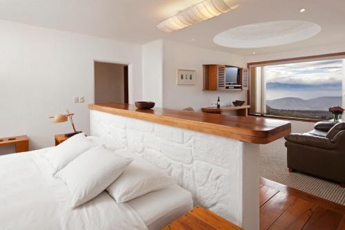 a living room with a white couch and a large window at El Crater in San Antonio