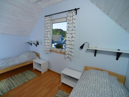 a bedroom with two beds and a window at Holiday homes, Rewal in Rewal