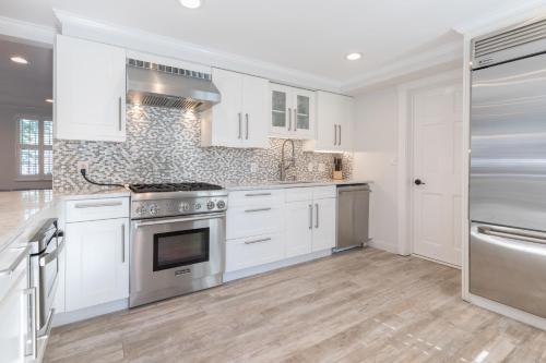 a kitchen with white cabinets and a stove top oven at 45A Pleasant St in Nantucket